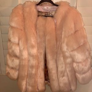 Soft pink faux fur coat. Warm snuggly. Unique lining. Side pockets.